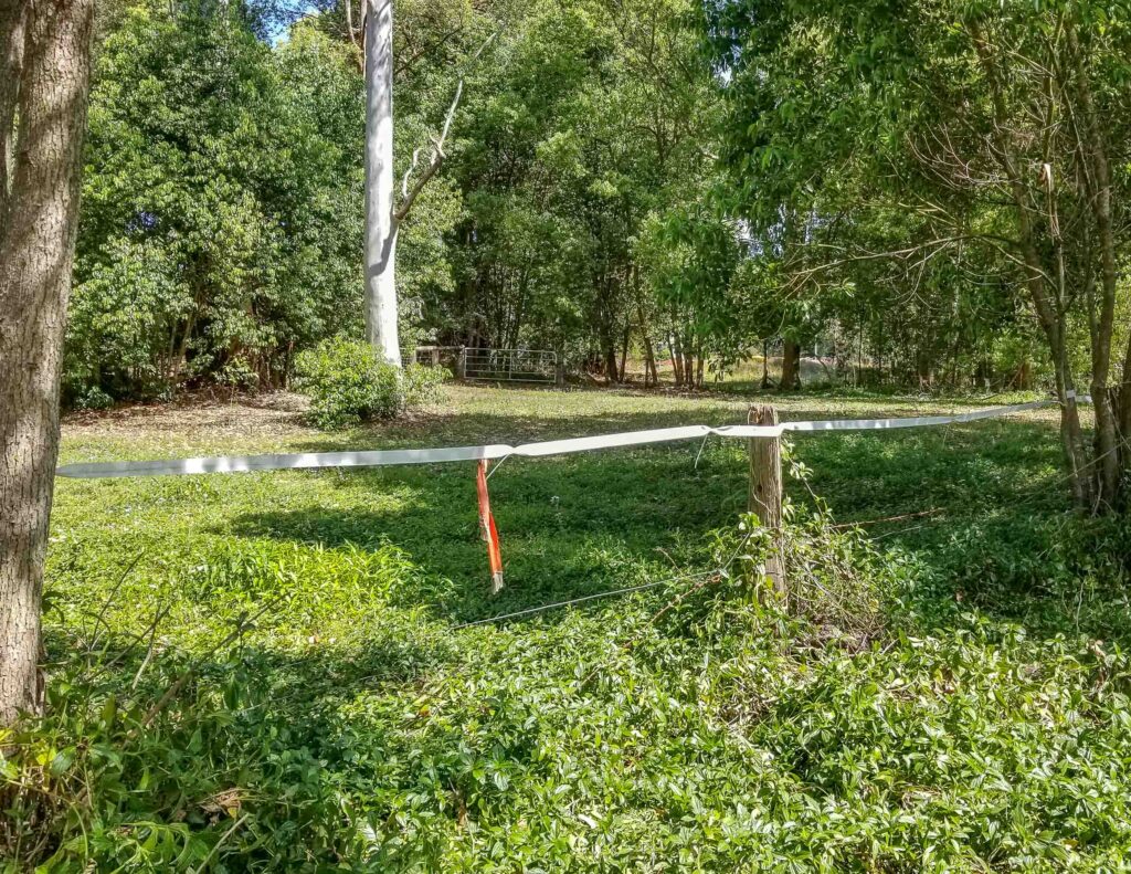 Covering barbed wire with wildlife friendly white poly tape increasing its visibility to wildlife